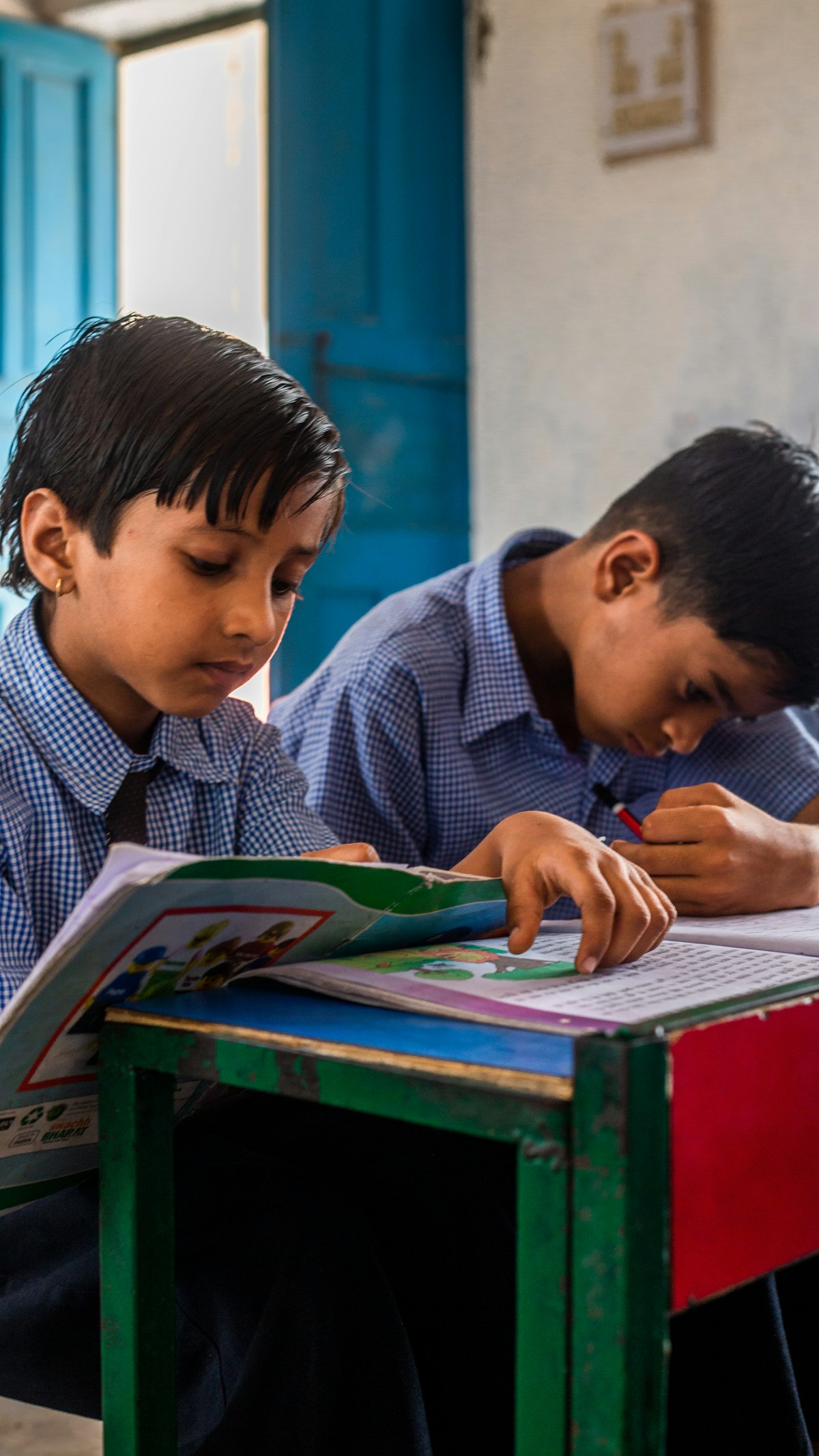 School boys studying their textbooks